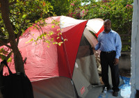 Haiti staff member stands with his tent.
