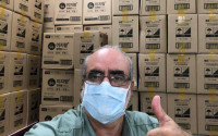 WOCCU President/CEO Brian Branch with boxes of masks donated by NACUFOK