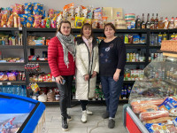 (From left to right) Ms. Nadiya in her grocery store with a credit union manager and her store employee