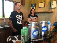 Marcos Paulino (left) created a community development project for dairy farmers through his Sicredi Youth Committee.