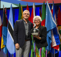 Oleg Lebedko accepting his 2023 Distinguished Service Award from WOCCU Board Chair Diana Dykstra