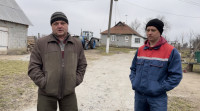 Oleksandr Karelin (left) with an employee on his farm in Kyiv Oblast