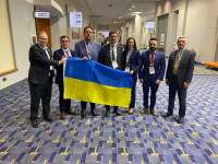 WOCCU executives and Ukrainian American credit union leaders hold a Ukrainian flag to show unity