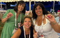 Credit union peers smiling with their ICU Day pins at the Gala at Thompson Island.